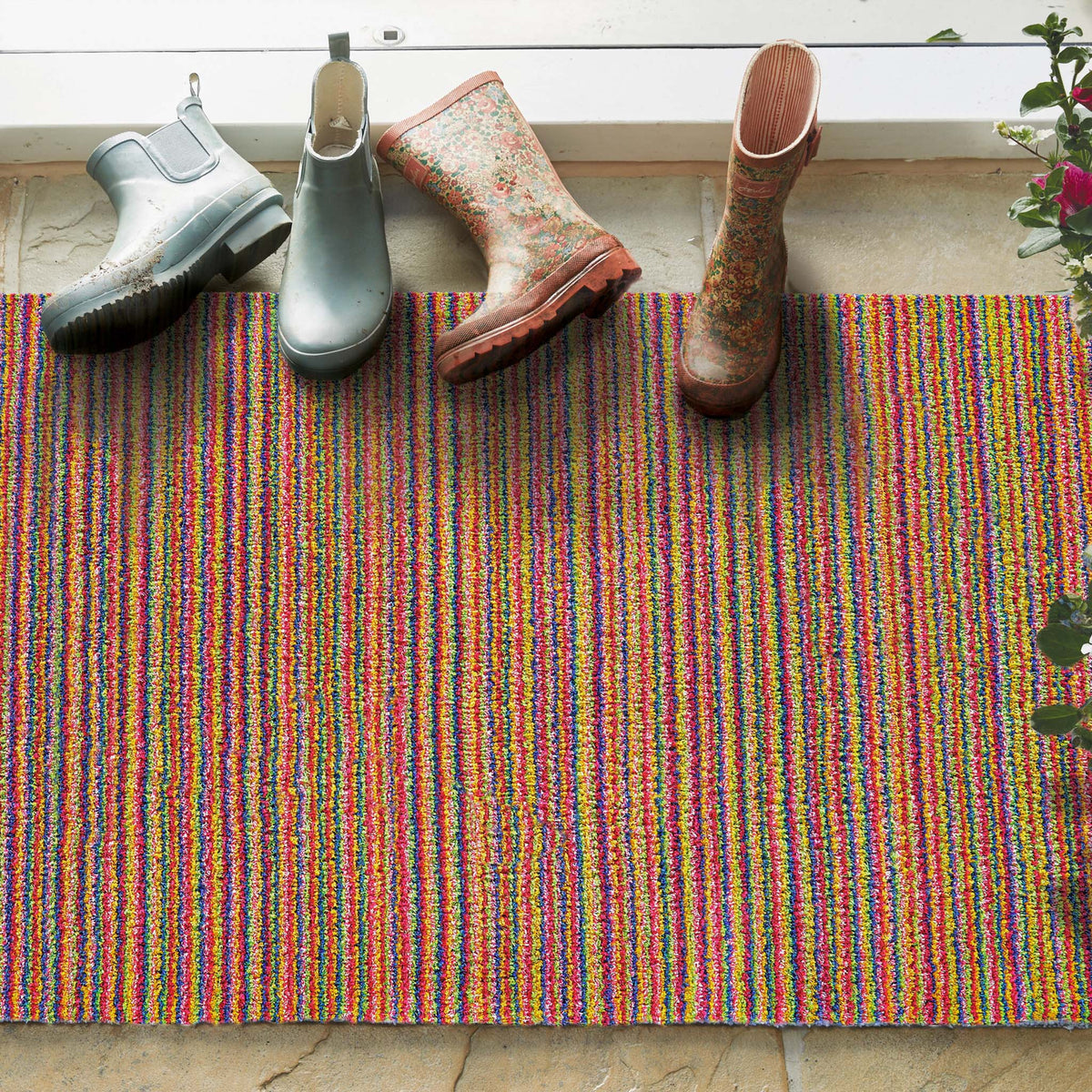 Candy Bright Doormat - a 100% recycled material doormat featuring a colourful striped pattern.