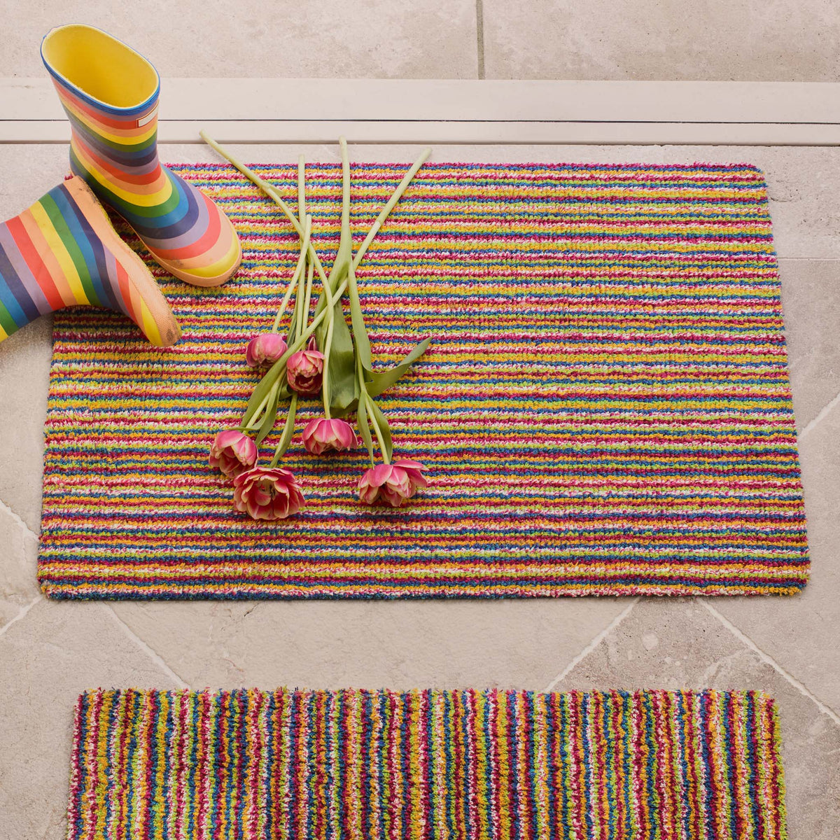 Candy Bright Doormat - a 100% recycled material doormat featuring a colourful striped pattern.