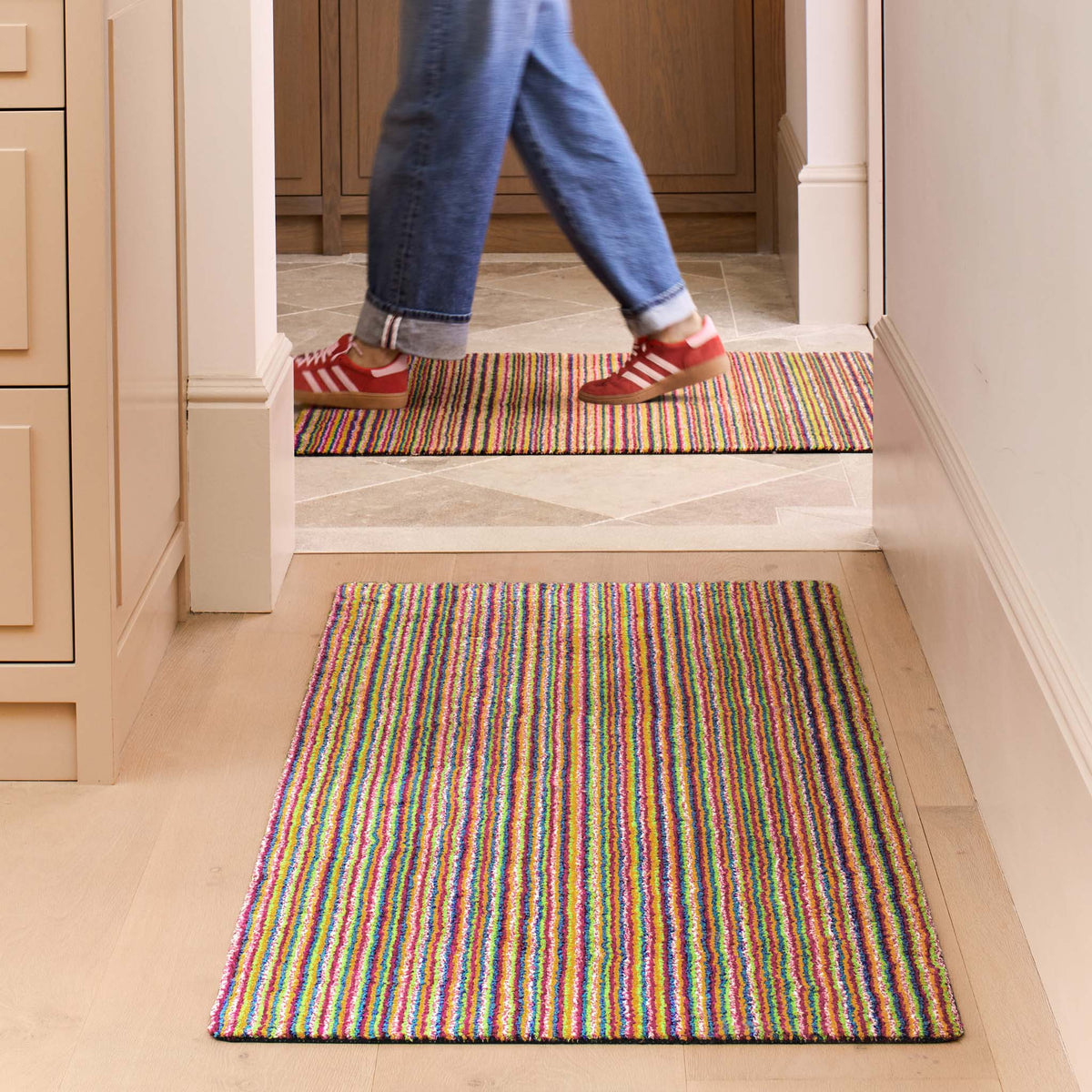 Candy Bright Multi Washable Runner with a striped design, styled in a entryway.